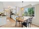 Eat-in kitchen offers a dining table, stainless steel appliances, and backyard view from a large window at 2166 Carlyle Dr, Marietta, GA 30062