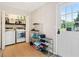 Functional laundry room with washer, dryer, storage shelves, and access to backyard at 2166 Carlyle Dr, Marietta, GA 30062