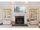 Bright living room featuring fireplace, mantle decor, stylish shelving units and neutral carpeting at 2166 Carlyle Dr, Marietta, GA 30062