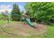 A wooden playset including swings and a slide surrounded by green lawn at 2166 Carlyle Dr, Marietta, GA 30062