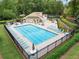 Community pool featuring lounge chairs and tables, surrounded by lush greenery, and offering a relaxing recreational space at 2166 Carlyle Dr, Marietta, GA 30062