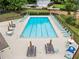 Large outdoor pool with lounge chairs and tables, perfect for relaxing and enjoying the summer at 2166 Carlyle Dr, Marietta, GA 30062