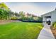 Large, fenced-in back yard with soccer net and mature trees at 2381 Jones Phillips Rd, Dacula, GA 30019