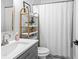 Stylish bathroom with a modern vanity, a sleek mirror, and a shower featuring a crisp white curtain at 2381 Jones Phillips Rd, Dacula, GA 30019