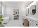 Stylish bathroom showcasing a soaking tub, and vanity overlooking the main bedroom at 2381 Jones Phillips Rd, Dacula, GA 30019