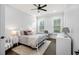 Well-lit bedroom featuring a metal bed frame, neutral decor, and hardwood flooring at 2381 Jones Phillips Rd, Dacula, GA 30019