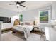 Sunlit bedroom with a cozy bed, chair, and hardwood flooring at 2381 Jones Phillips Rd, Dacula, GA 30019
