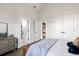 Bedroom with a bed, dresser, and multiple doors at 2381 Jones Phillips Rd, Dacula, GA 30019