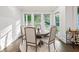 Bright dining area with large windows, neutral furniture, and access to the backyard at 2381 Jones Phillips Rd, Dacula, GA 30019