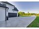 Long driveway to a two-car garage on a white brick home at 2381 Jones Phillips Rd, Dacula, GA 30019
