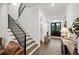 Elegant entryway with stairs, dark hardwood floors, and stylish decor leading to the front door at 2381 Jones Phillips Rd, Dacula, GA 30019
