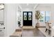 Bright foyer with dark wood floors, a decorative rug, and charming wreath-adorned double doors at 2381 Jones Phillips Rd, Dacula, GA 30019