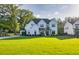 Beautiful two-story home with a well-manicured lawn, black trim windows, and a welcoming driveway at 2381 Jones Phillips Rd, Dacula, GA 30019