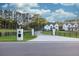 Long driveway leads to a black gate with a white brick mail post on a sunny day at 2381 Jones Phillips Rd, Dacula, GA 30019