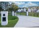 Elegant driveway entrance with a black iron gate and white brick pillars at 2381 Jones Phillips Rd, Dacula, GA 30019