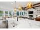 Open-concept kitchen with a large island, farmhouse sink, and views of the living room and dining area at 2381 Jones Phillips Rd, Dacula, GA 30019