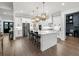 Bright and spacious kitchen showcasing an island with bar seating, custom cabinets, and stainless steel appliances at 2381 Jones Phillips Rd, Dacula, GA 30019