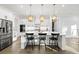 Modern kitchen with an island, pendant lighting, and stainless steel appliances at 2381 Jones Phillips Rd, Dacula, GA 30019