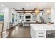 Open-concept kitchen featuring an island, dining area, and living room with a fireplace and built-in shelves at 2381 Jones Phillips Rd, Dacula, GA 30019