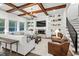 Stunning living room with exposed beams, built-in shelving, and large windows overlooking the backyard at 2381 Jones Phillips Rd, Dacula, GA 30019