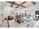 Open-concept living room with hardwood floors, built-in shelves, a fireplace, and a view of the kitchen at 2381 Jones Phillips Rd, Dacula, GA 30019