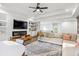 Bright living room with a plush sectional sofa, fireplace, and hardwood flooring at 2381 Jones Phillips Rd, Dacula, GA 30019