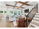 Bright living room featuring hardwood floors, a fireplace, built-in bookshelves, and an open staircase at 2381 Jones Phillips Rd, Dacula, GA 30019