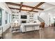 Bright and airy living room featuring a fireplace with built-ins, hardwood floors, and an open staircase at 2381 Jones Phillips Rd, Dacula, GA 30019