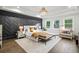 Bright main bedroom featuring a decorative accent wall, tray ceiling, and luxury finishes at 2381 Jones Phillips Rd, Dacula, GA 30019