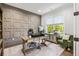 Stylish office with a custom accent wall, natural light, and a comfortable workstation setup at 2381 Jones Phillips Rd, Dacula, GA 30019