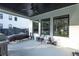 Covered patio area with grill, seating and overhead ceiling fan at 2381 Jones Phillips Rd, Dacula, GA 30019