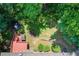 Aerial view of the backyard revealing a stone walkway, trampoline and surrounding verdant trees at 245 Ashley Forest Dr, Fayetteville, GA 30214