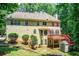 Expansive back exterior featuring multi-level deck, stone patio, and mature landscaping at 245 Ashley Forest Dr, Fayetteville, GA 30214