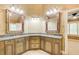 Bathroom boasts dual sinks, decorative mirrors, and stone countertops, exuding elegance and functionality at 245 Ashley Forest Dr, Fayetteville, GA 30214