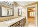 Bathroom features double sinks with granite countertop, cabinets, and dual mirrors at 245 Ashley Forest Dr, Fayetteville, GA 30214