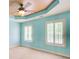 Bedroom with light blue walls, neutral carpet, ceiling fan and shuttered windows at 245 Ashley Forest Dr, Fayetteville, GA 30214