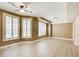 Spacious bedroom features natural light from multiple windows, wood-look flooring, and neutral walls at 245 Ashley Forest Dr, Fayetteville, GA 30214