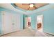 Bright bedroom with a ceiling fan, a double door closet, and an adjacent bathroom with a wooden vanity at 245 Ashley Forest Dr, Fayetteville, GA 30214