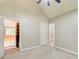 A neutral-colored bedroom featuring a doorway to a bathroom, carpet and white doors at 245 Ashley Forest Dr, Fayetteville, GA 30214