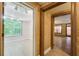 Hallway with wood-look floors and access to living and recreational rooms at 245 Ashley Forest Dr, Fayetteville, GA 30214