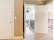 A hallway with view of a bathroom featuring dark vanity and a staircase with railing at 245 Ashley Forest Dr, Fayetteville, GA 30214