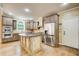 Bright kitchen with stainless steel appliances, center island, and decorative cabinets at 245 Ashley Forest Dr, Fayetteville, GA 30214