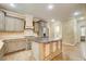 Kitchen featuring stainless steel appliances, island, and access to the laundry room at 245 Ashley Forest Dr, Fayetteville, GA 30214