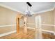 Spacious living room showcasing hardwood floors, crown molding, and access to multiple areas of the home at 245 Ashley Forest Dr, Fayetteville, GA 30214