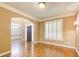 Inviting living room with hardwood floors, wainscoting, and natural light streaming through the shuttered windows at 245 Ashley Forest Dr, Fayetteville, GA 30214