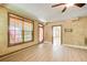 Cozy living room with wood-look flooring, a ceiling fan, textured walls, and a large window at 245 Ashley Forest Dr, Fayetteville, GA 30214