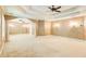A large main bedroom features neutral walls, carpet, a tray ceiling, and a ceiling fan at 245 Ashley Forest Dr, Fayetteville, GA 30214
