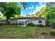 Back exterior of home featuring a charming patio with a white pergola, fire pit, and fenced yard at 755 Waterbrook Ter, Roswell, GA 30076