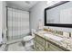Neutral bathroom featuring vanity with granite countertop and shower with patterned curtain at 755 Waterbrook Ter, Roswell, GA 30076
