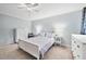 Bright bedroom with ceiling fan, neutral walls and furnishings, and soft carpet at 755 Waterbrook Ter, Roswell, GA 30076